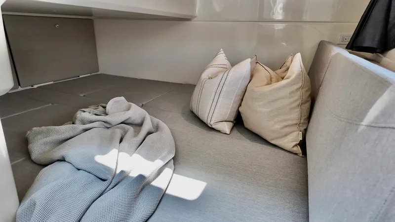 Slide: The Image of Cozy interior of 2025 Bayliner Trophy 29 Explorer with cushions and blanket. - 19