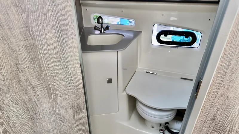 Slide: The Image of 2025 Bayliner Trophy 29 Explorer bathroom with sink and toilet, featuring modern design. - 22
