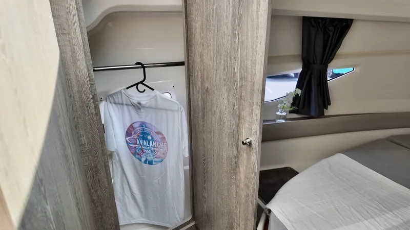 Slide: The Image of Interior of 2025 Bayliner Trophy 29 Explorer with closet and bed. - 24