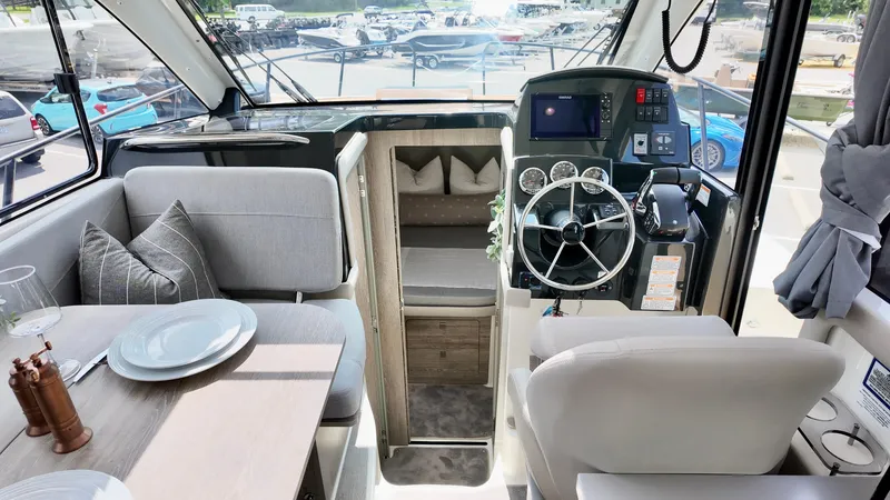 Slide: The Image of Interior of 2025 Bayliner Trophy 29 Explorer boat with helm and dining area. - 30