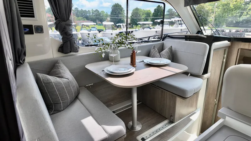 Slide: The Image of Interior of 2025 Bayliner Trophy 29 Explorer with cozy dining area and modern decor. - 9
