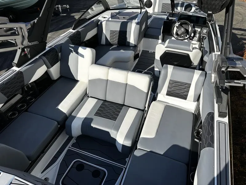 Slide: The Image of 2025 Malibu Wakesetter 24 MXZ interior with luxurious seating and modern design. - 11