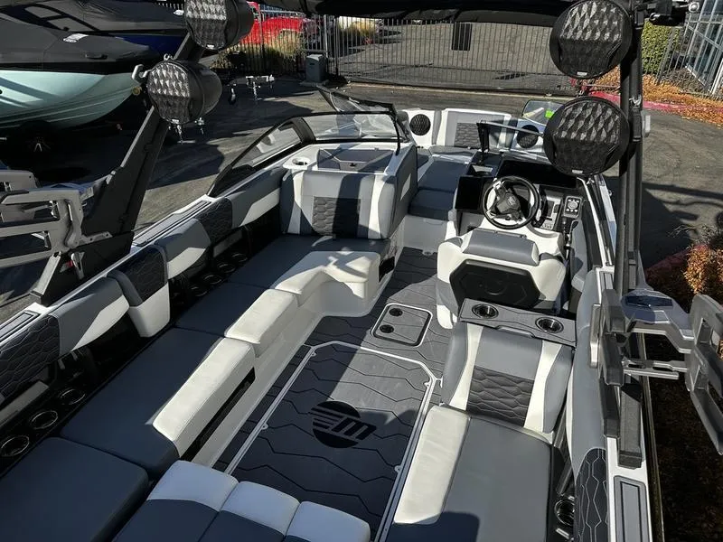 Slide: The Image of 2025 Malibu Wakesetter 24 MXZ interior with sleek seating and modern dashboard design. - 6