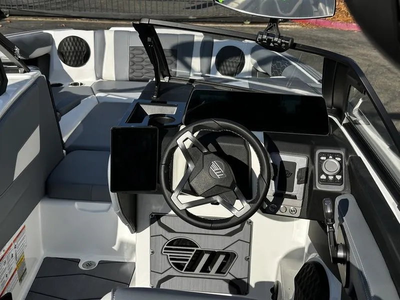Slide: The Image of Interior of 2025 Malibu Wakesetter 24 MXZ boat, featuring modern steering and controls. - 7