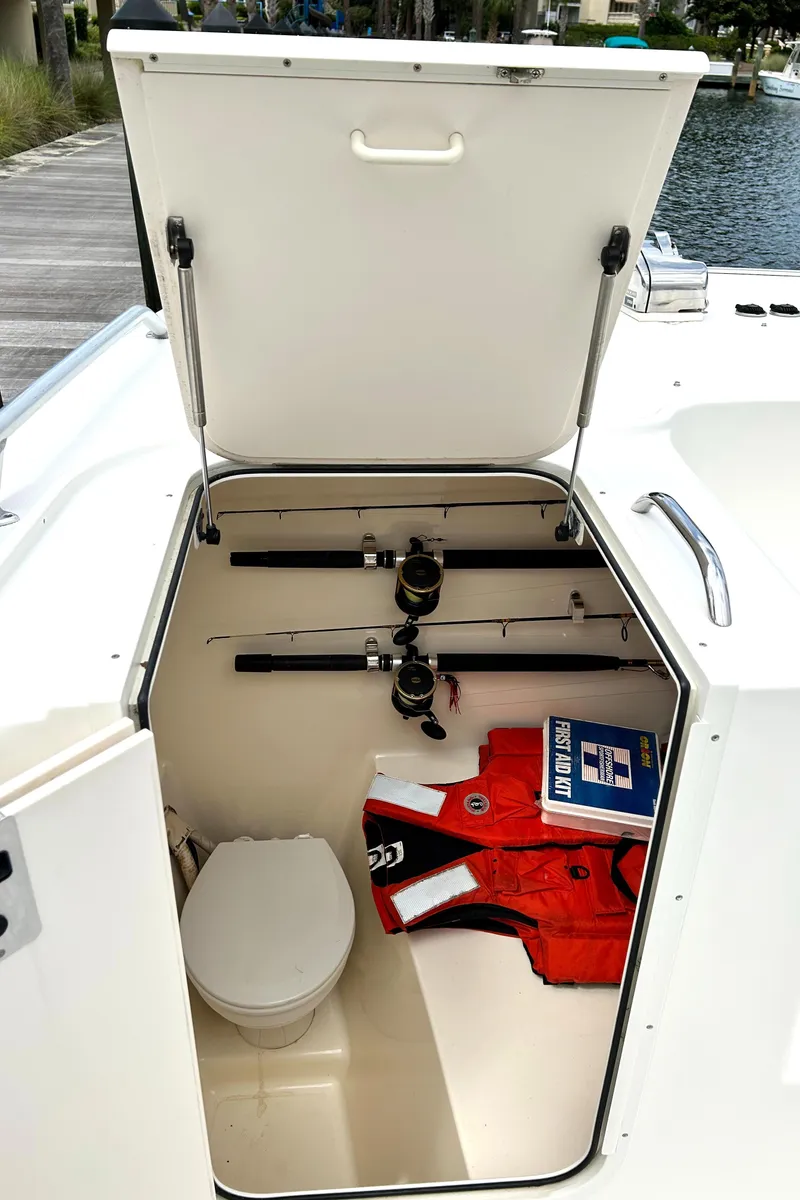 Slide: The Image of 2008 World Cat 330 TE boat storage with fishing rods, life jacket, and marine toilet. - 10