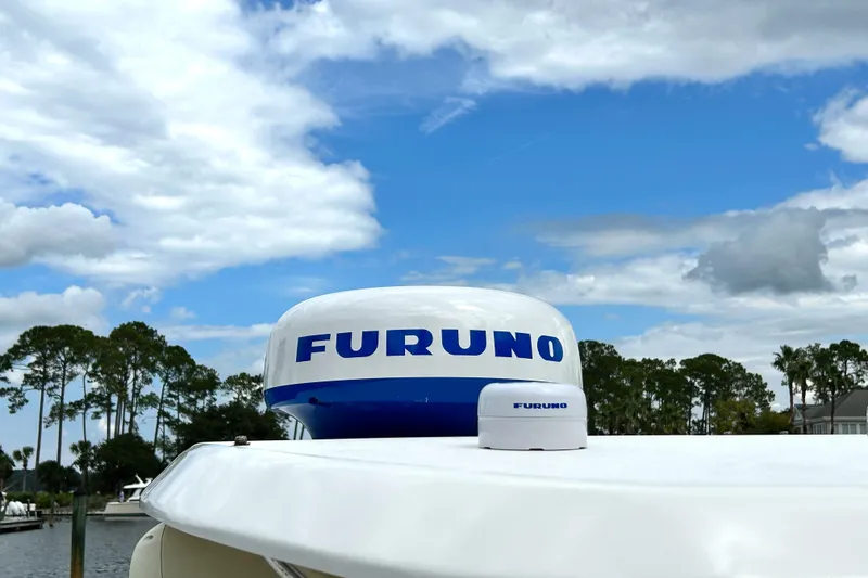 Slide: The Image of 2008 World Cat 330 TE boat with Furuno radar against a cloudy sky. - 13