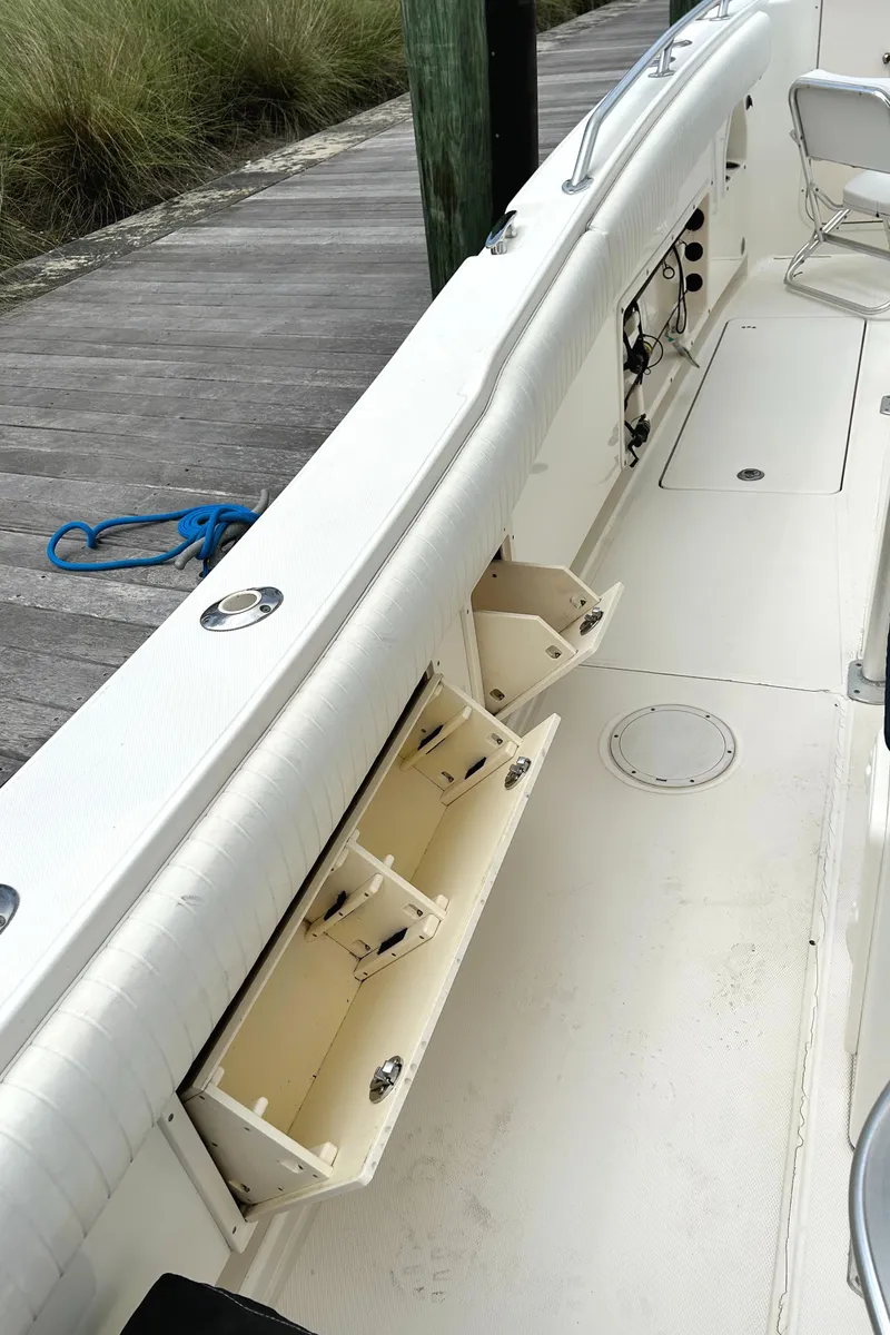 Slide: The Image of 2008 World Cat 330 TE boat interior with storage compartments and seating. - 16