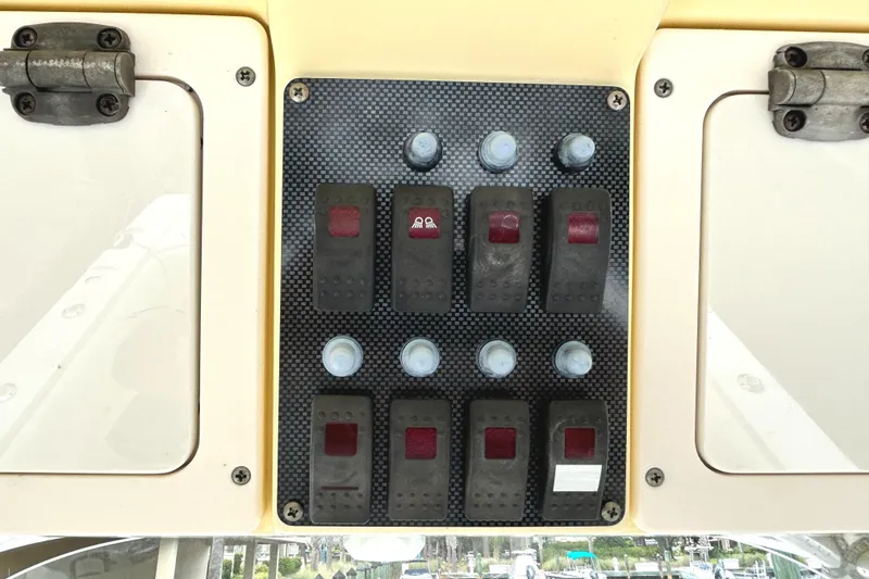 Slide: The Image of Control panel on a 2008 World Cat 330 TE boat with switches and buttons. - 24