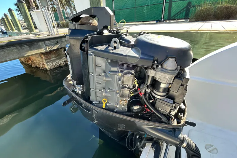 Slide: The Image of Outboard motor of a 2008 World Cat 330 TE boat docked by the water. - 28