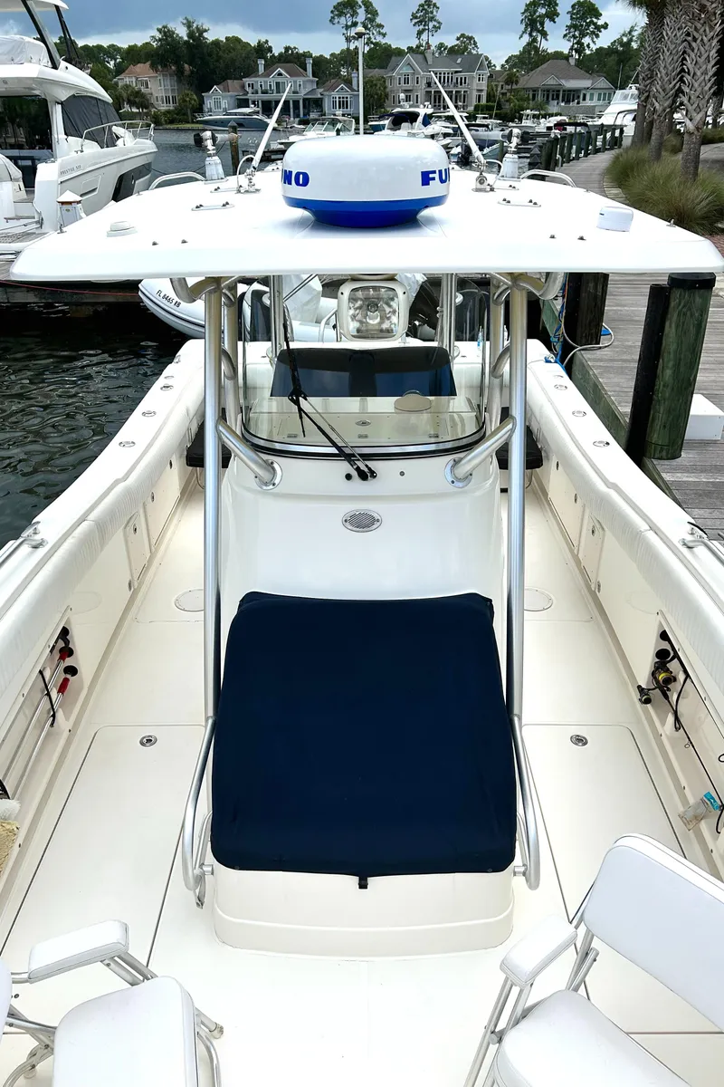 Slide: The Image of 2008 World Cat 330 TE boat docked, featuring spacious deck and seating. - 6