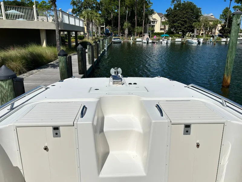 Slide: The Image of 2008 World Cat 330 TE boat docked in a serene marina setting. - 8