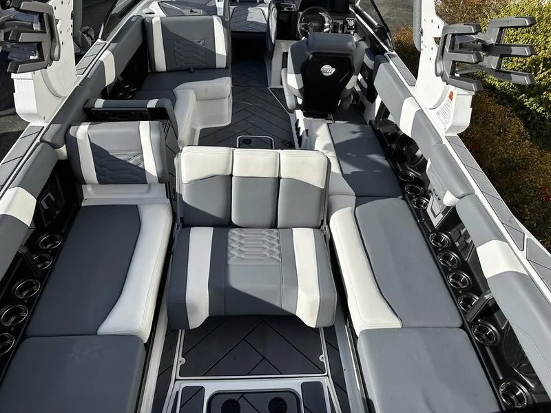 Slide: The Image of 2025 Malibu Wakesetter 26 LSV interior with gray and white seating, spacious layout. - 6