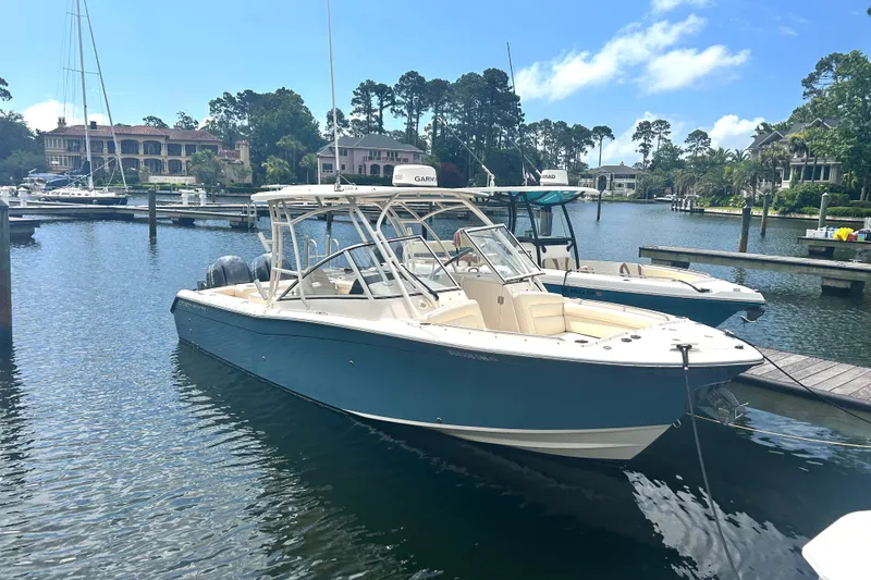 Slide: The Image of 2020 Grady-White Freedom 275 boat docked in a scenic marina. - 0