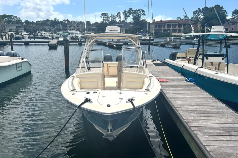 Slide: The Image of 2020 Grady-White Freedom 275 boat docked in a marina. - 1