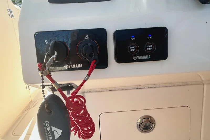 Slide: The Image of Yamaha controls on 2020 Grady-White Freedom 275 boat dashboard with safety lanyard. - 15