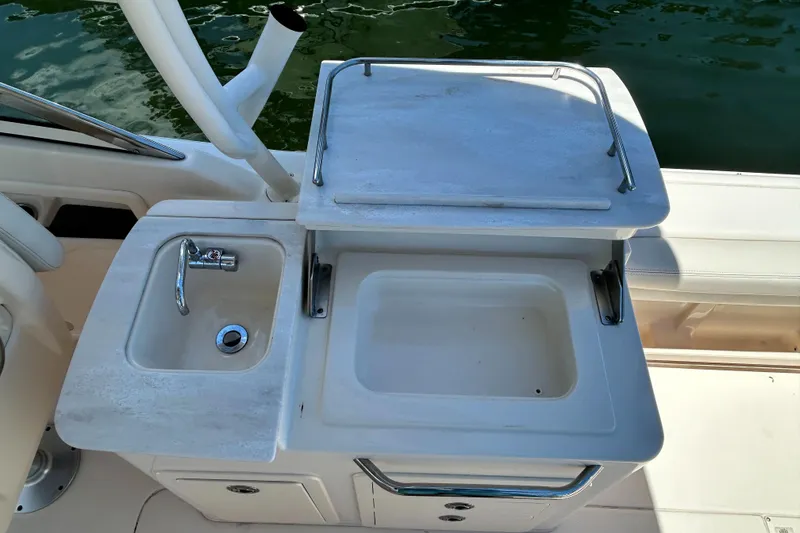 Slide: The Image of 2020 Grady-White Freedom 275 boat sink and prep station with storage. - 18