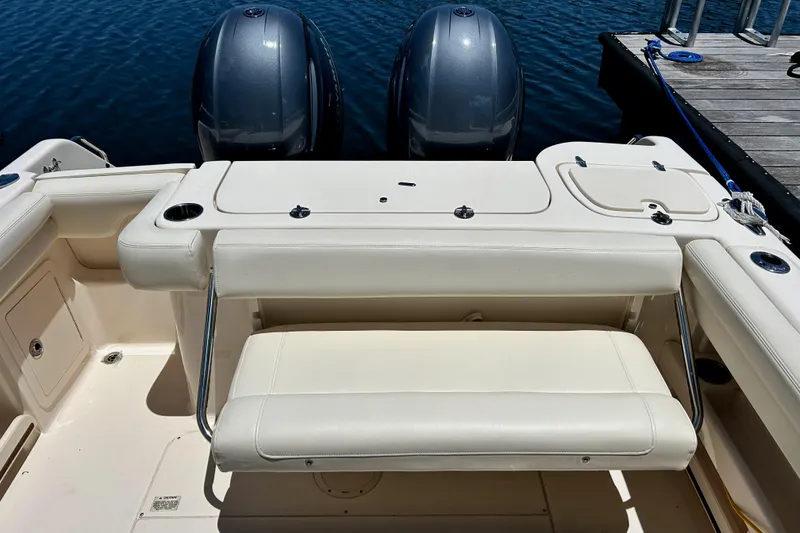 Slide: The Image of 2020 Grady-White Freedom 275 boat with dual engines and seating, docked by the water. - 19