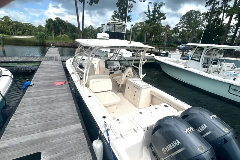 Slide: The Image of 2020 Grady-White Freedom 275 boat docked with twin Yamaha engines. - 2