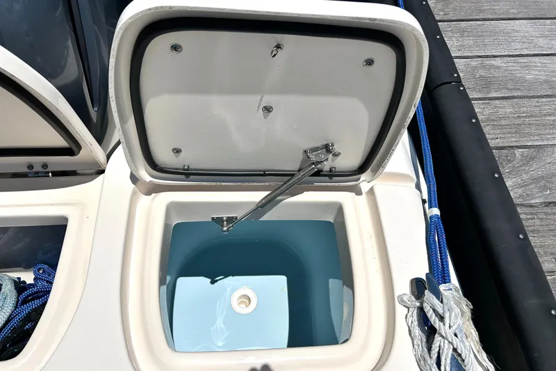 Slide: The Image of Open storage compartment on 2020 Grady-White Freedom 275 boat, showing interior details. - 21