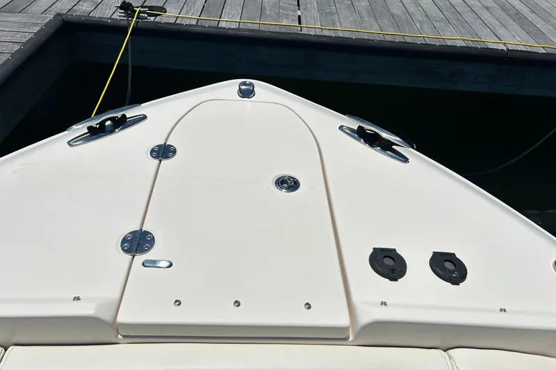 Slide: The Image of 2020 Grady-White Freedom 275 boat deck, docked, showcasing sleek design and hardware. - 23