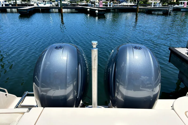 Slide: The Image of Twin outboard engines on a 2020 Grady-White Freedom 275 at a marina. - 5