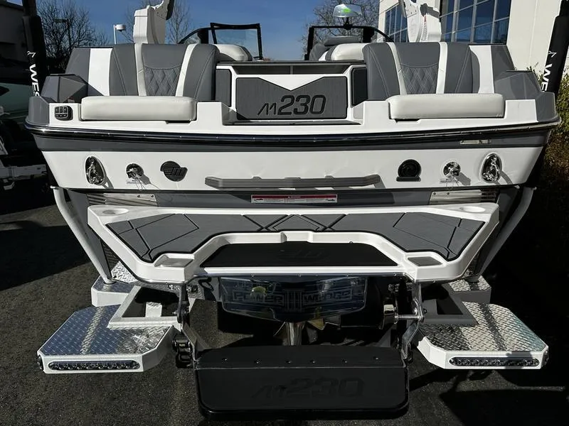 Slide: The Image of 2025 Malibu M230 boat rear view with sleek design and modern features. - 3