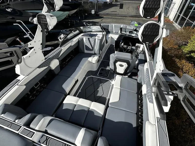 Slide: The Image of 2025 Malibu M230 boat interior with sleek seating and modern design. - 4