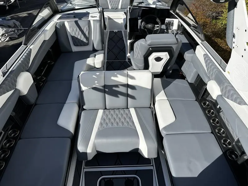 Slide: The Image of 2025 Malibu M230 boat interior with luxurious gray seating and modern design. - 5