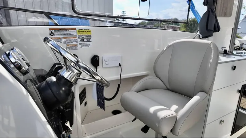Slide: The Image of 2025 Bayliner TROPHY 25 EXPLORER helm with steering wheel and comfortable captain's chair. - 17