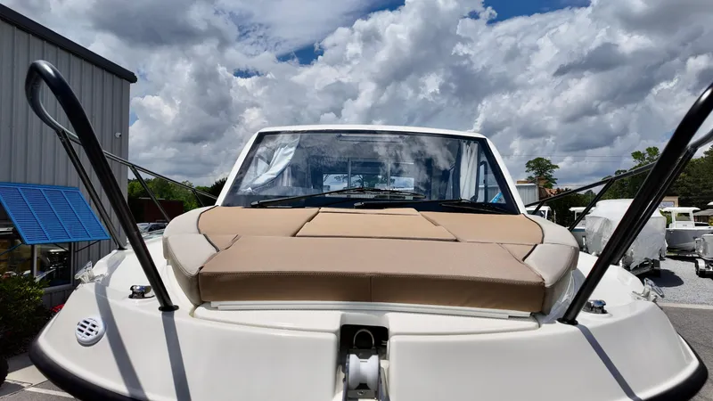 Slide: The Image of 2025 Bayliner TROPHY 25 EXPLORER boat with cushioned deck, under cloudy sky. - 2