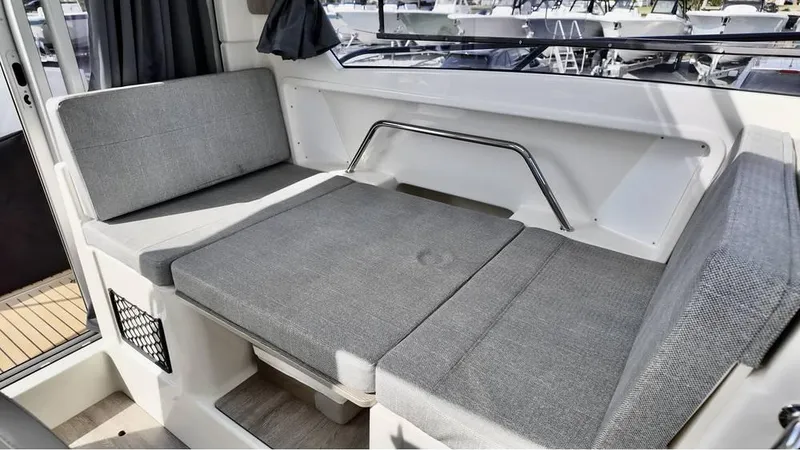 Slide: The Image of 2025 Bayliner TROPHY 25 EXPLORER interior seating area with gray cushions. - 20