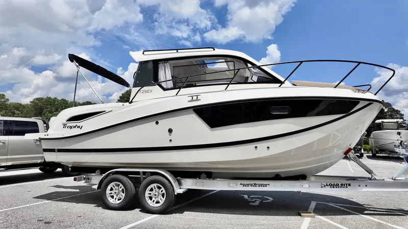 Slide: The Image of 2025 Bayliner TROPHY 25 EXPLORER boat on trailer under blue sky. - 3