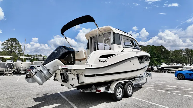 Slide: The Image of 2025 Bayliner TROPHY 25 EXPLORER boat on trailer in parking lot. - 4