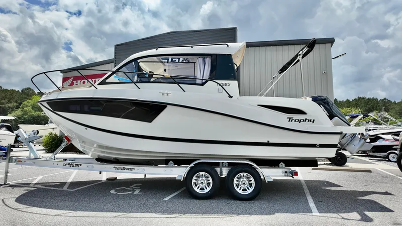 Slide: The Image of 2025 Bayliner TROPHY 25 EXPLORER boat on trailer, parked outdoors. - 5