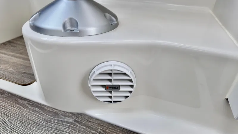 Slide: The Image of 2025 Bayliner TROPHY 25 EXPLORER boat interior detail with speaker and wood-textured flooring. - 8