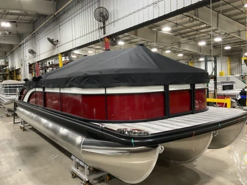 Slide: The Image of 2025 Bennington 24 SXSB pontoon boat with cover in a warehouse setting. - 16