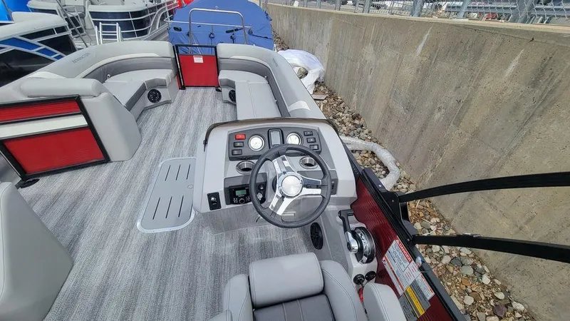 Slide: The Image of 2025 Bennington 24 SXSB boat interior with modern steering console and seating. - 23