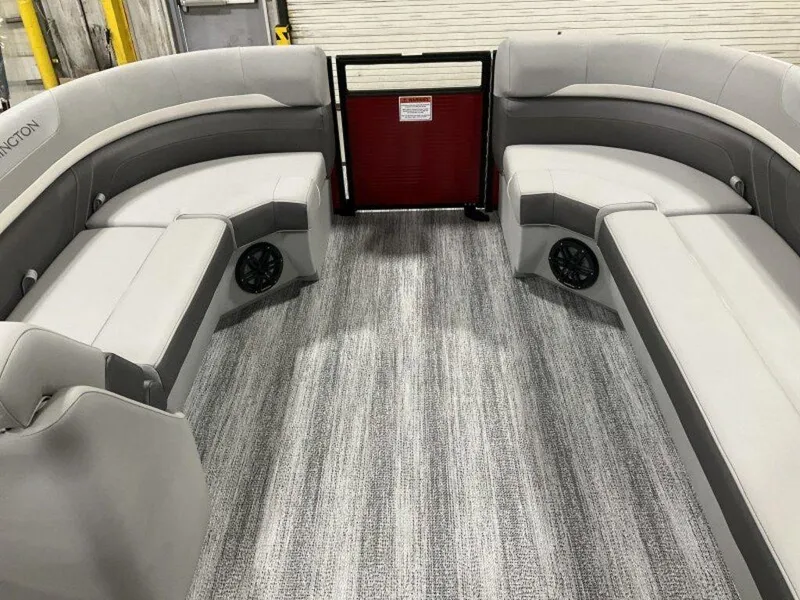 Slide: The Image of 2025 Bennington 24 SXSB boat interior with gray seating and carpet flooring. - 7