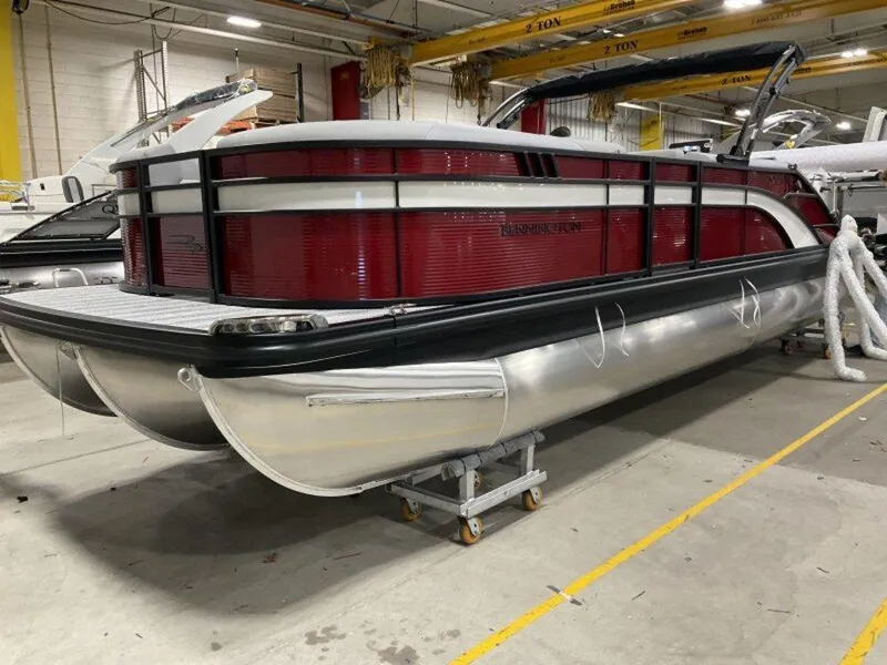 Slide: The Image of 2025 Bennington 24 SXSB pontoon boat in a warehouse setting. - 8