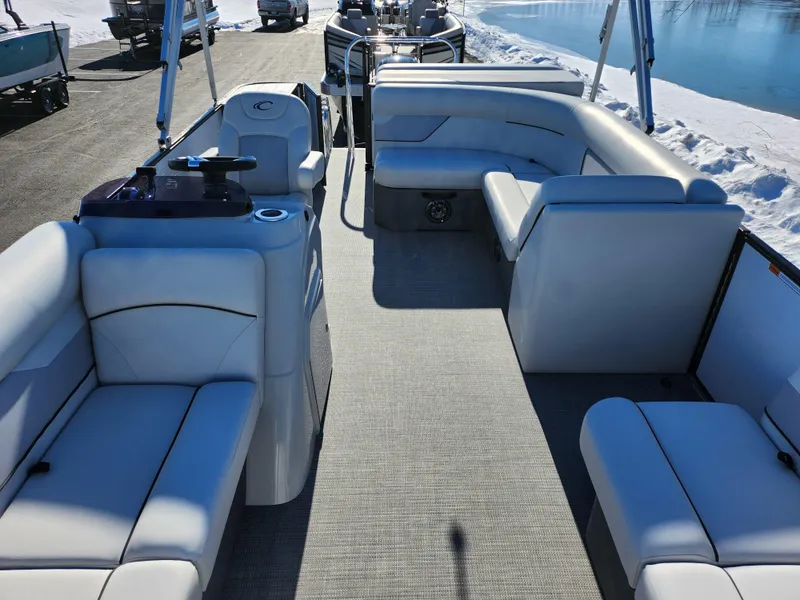 Slide: The Image of 2022 Crest Classic LX 200 pontoon boat interior with plush seating and modern design. - 11