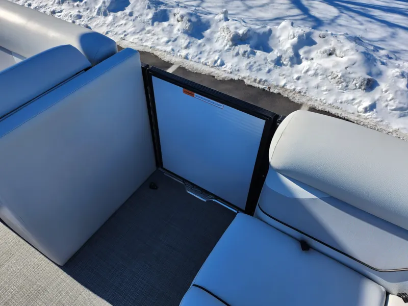 Slide: The Image of 2022 Crest Classic LX 200 boat interior with white seating and snowy background. - 12