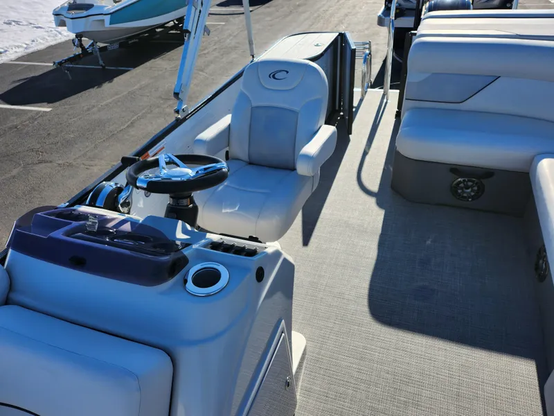 Slide: The Image of 2022 Crest Classic LX 200 boat interior with steering console and seating. - 13