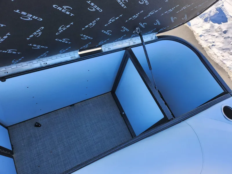 Slide: The Image of Open storage compartment in 2022 Crest Classic LX 200 boat. - 18
