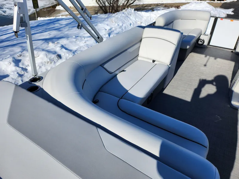 Slide: The Image of 2022 Crest Classic LX 200 boat interior with gray seating and snowy background. - 20