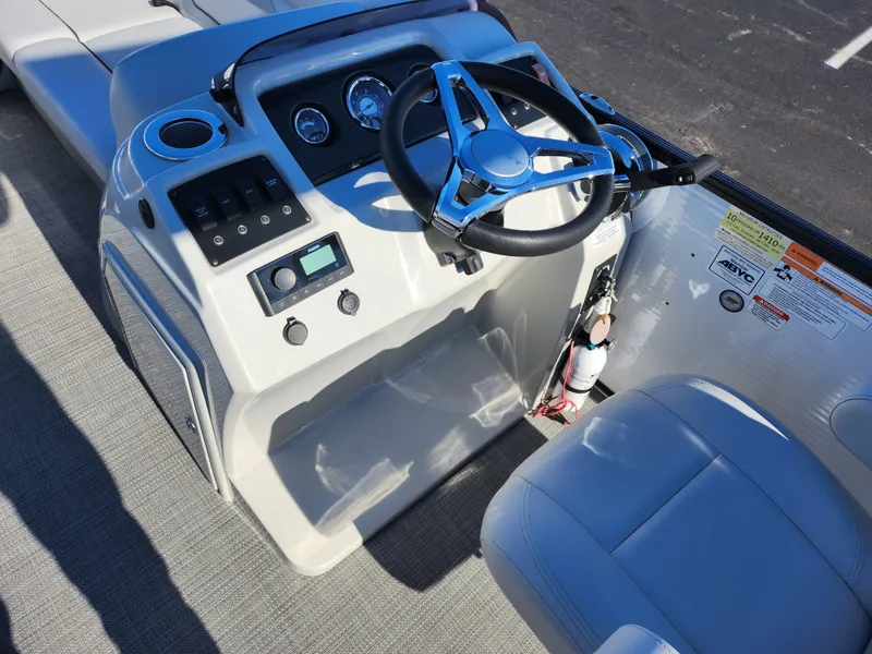 Slide: The Image of 2022 Crest Classic LX 200 boat dashboard with steering wheel and controls. - 22