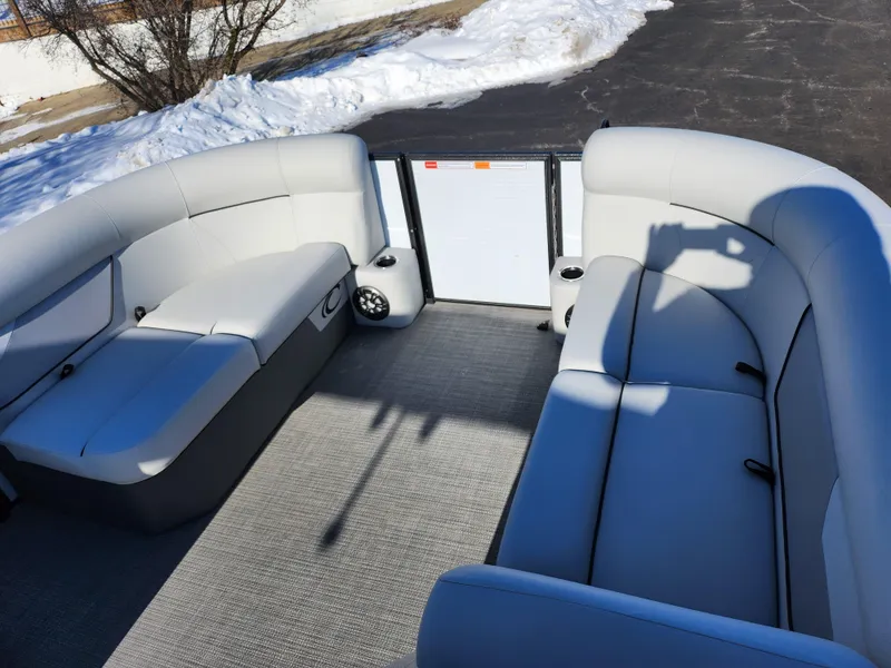 Slide: The Image of 2022 Crest Classic LX 200 pontoon boat interior with gray seating and carpet. - 24