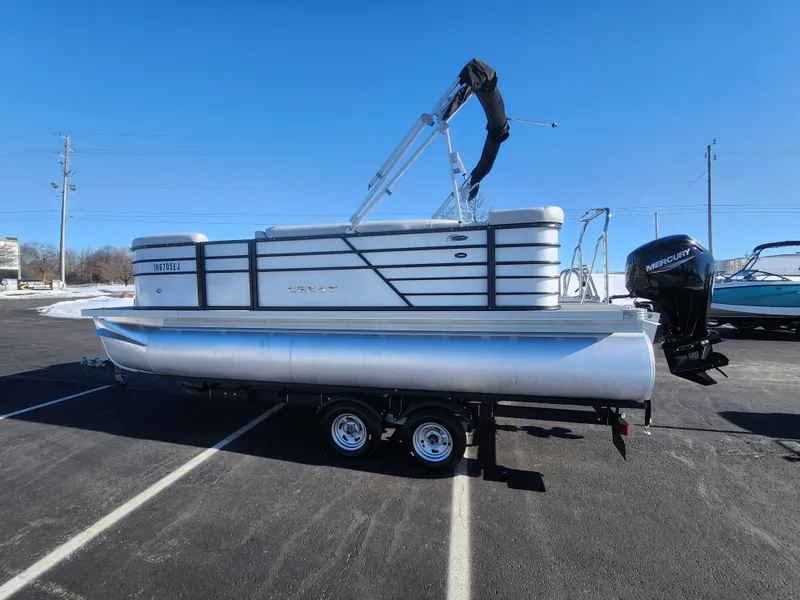 Slide: The Image of 2022 Crest Classic LX 200 pontoon boat on trailer in parking lot. - 4