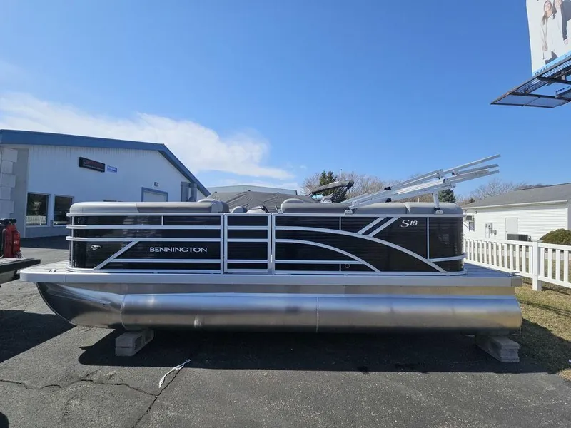 Slide: The Image of 2025 Bennington 188 SL pontoon boat parked outdoors on a sunny day. - 1