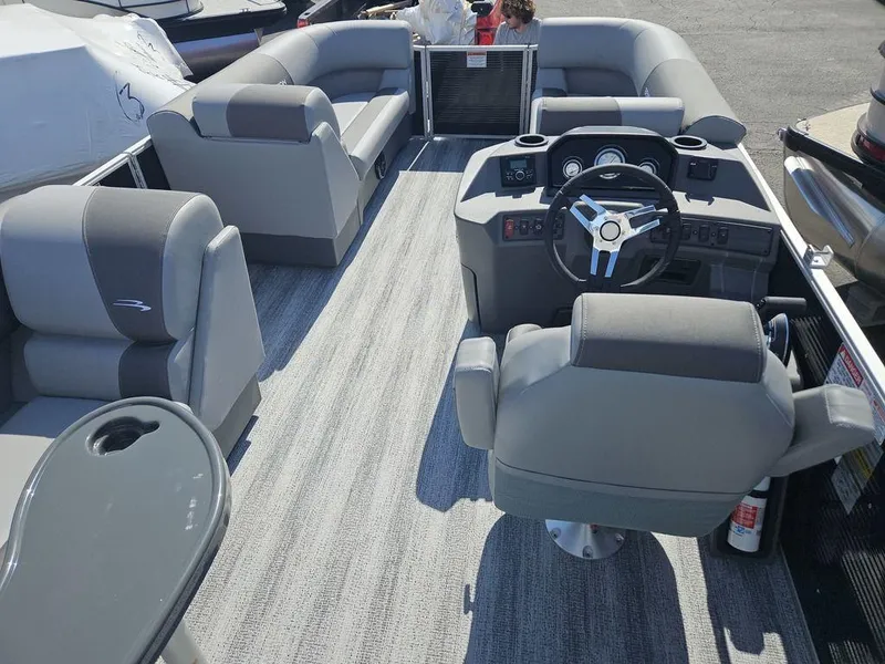Slide: The Image of 2025 Bennington 188 SL pontoon boat interior with gray seating and modern steering console. - 11