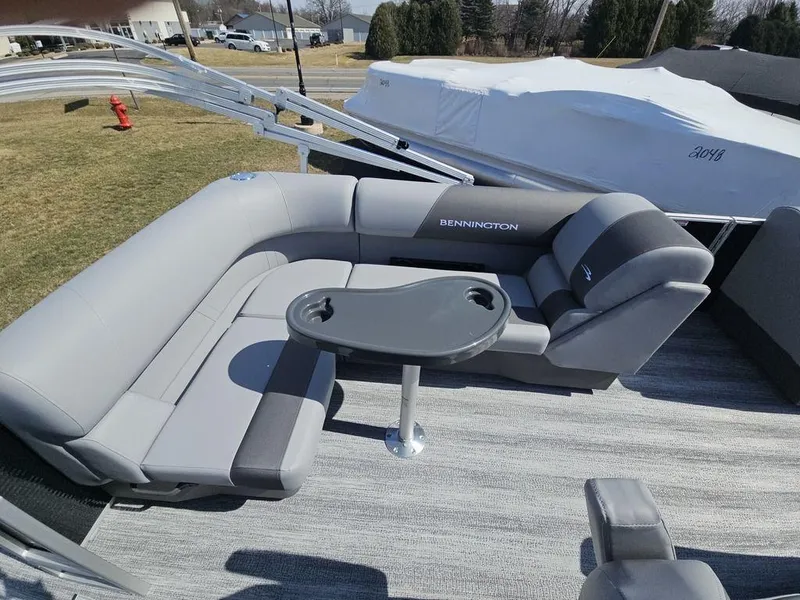 Slide: The Image of 2025 Bennington 188 SL pontoon boat with gray seating and a central table. - 12